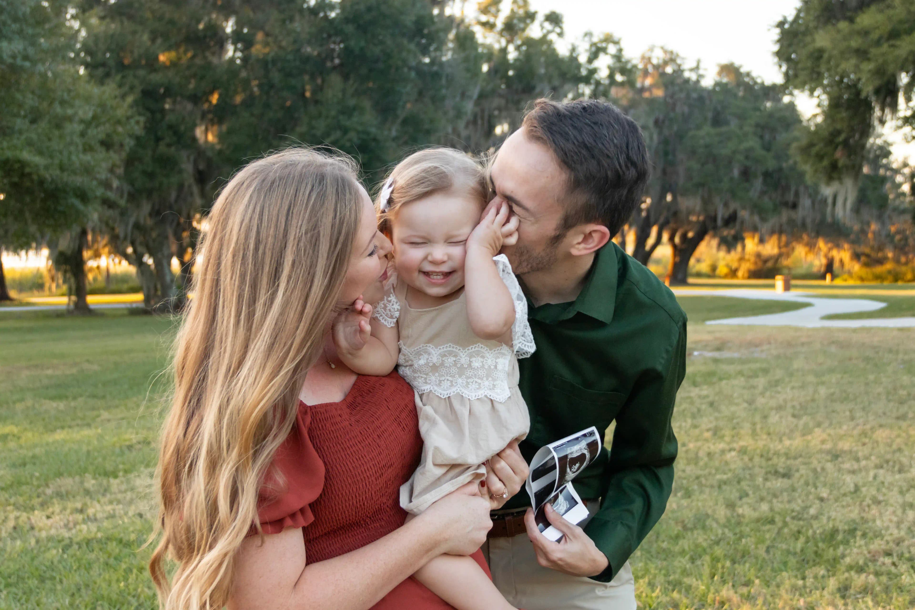 Family of three hugging