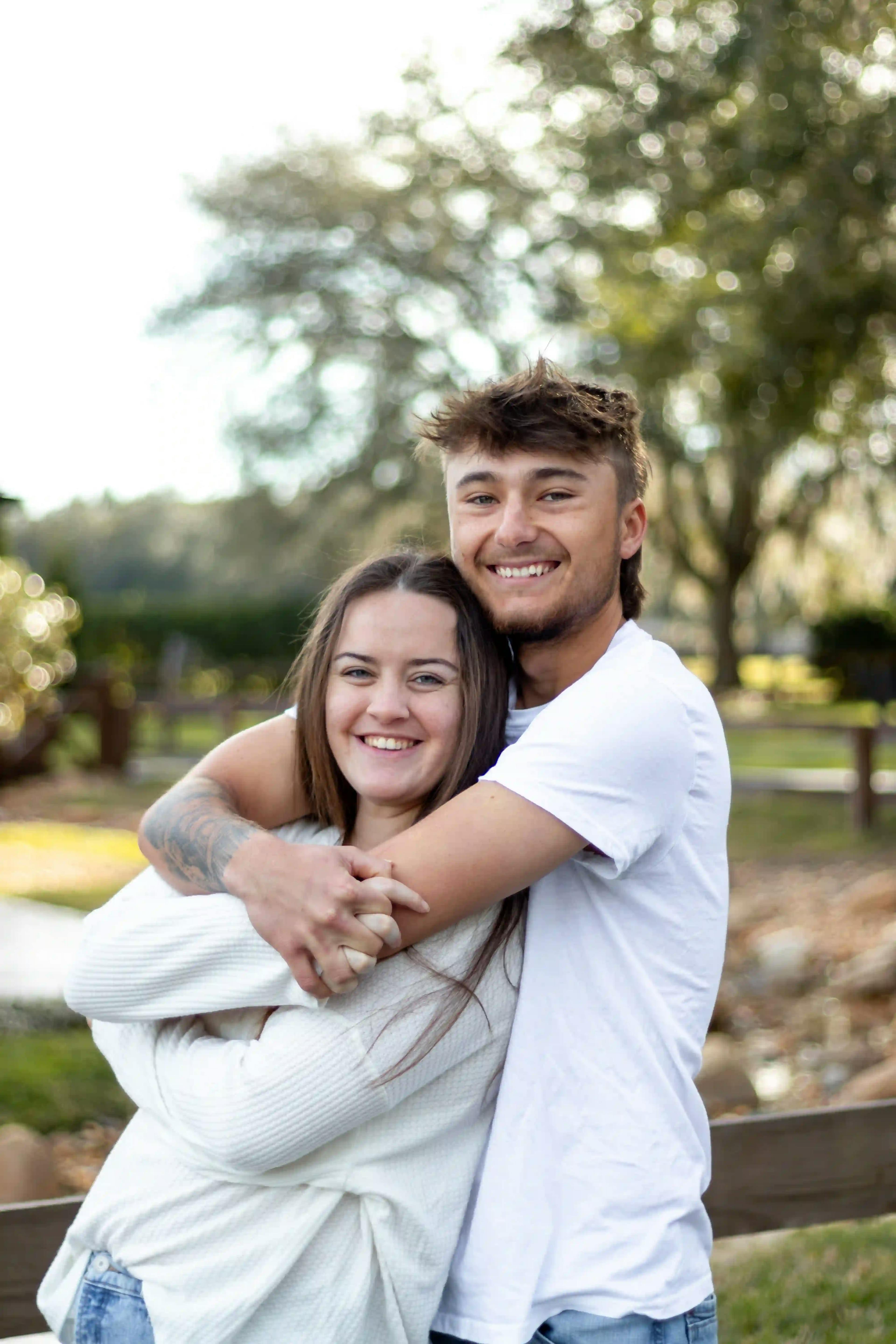 Young couple hugging in a beautiful rural florida landscape
