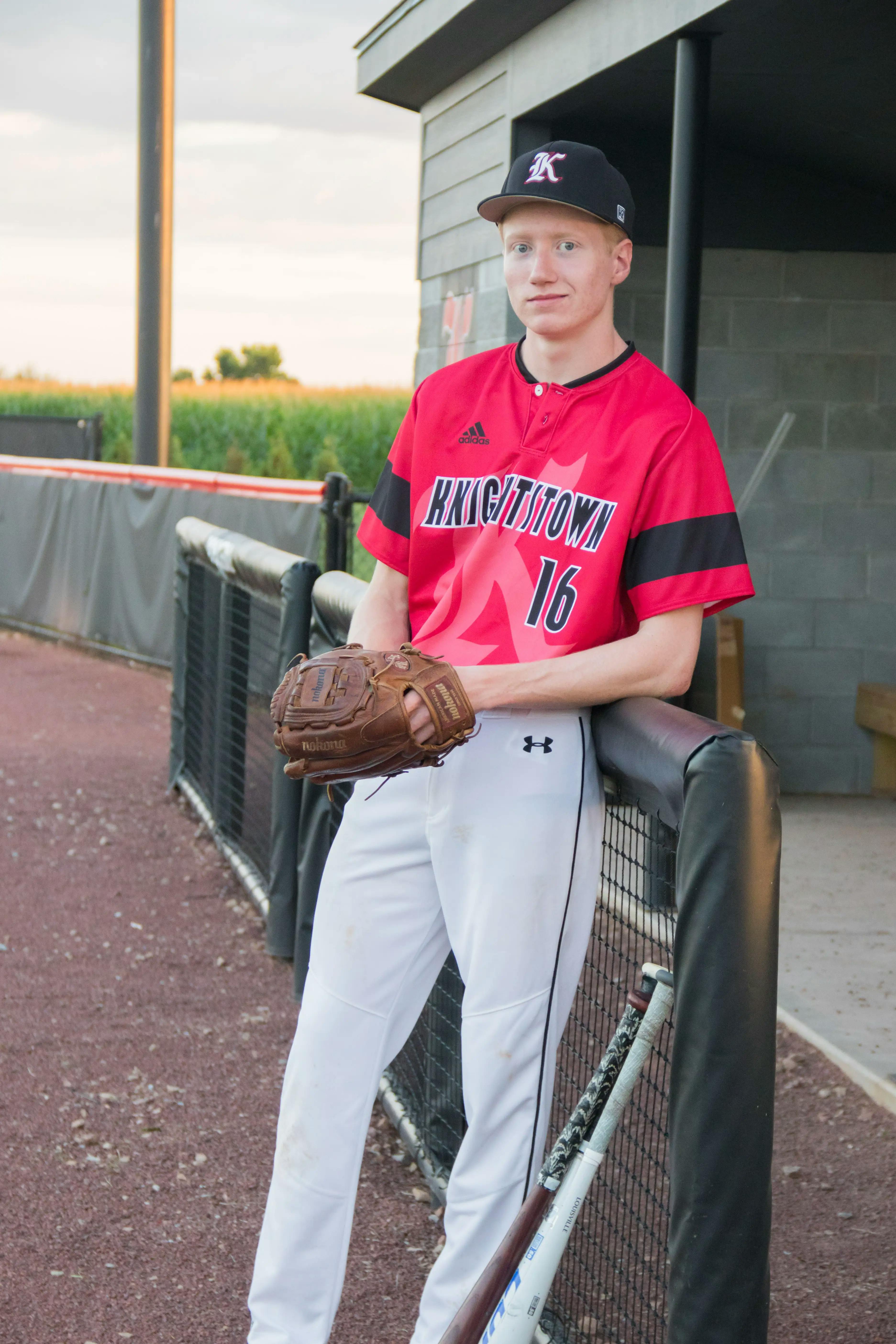 Male senior photo wearing baseball uniform
