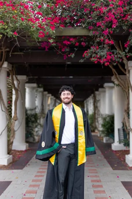 Male senior photo in graduation gown at University of South Florida