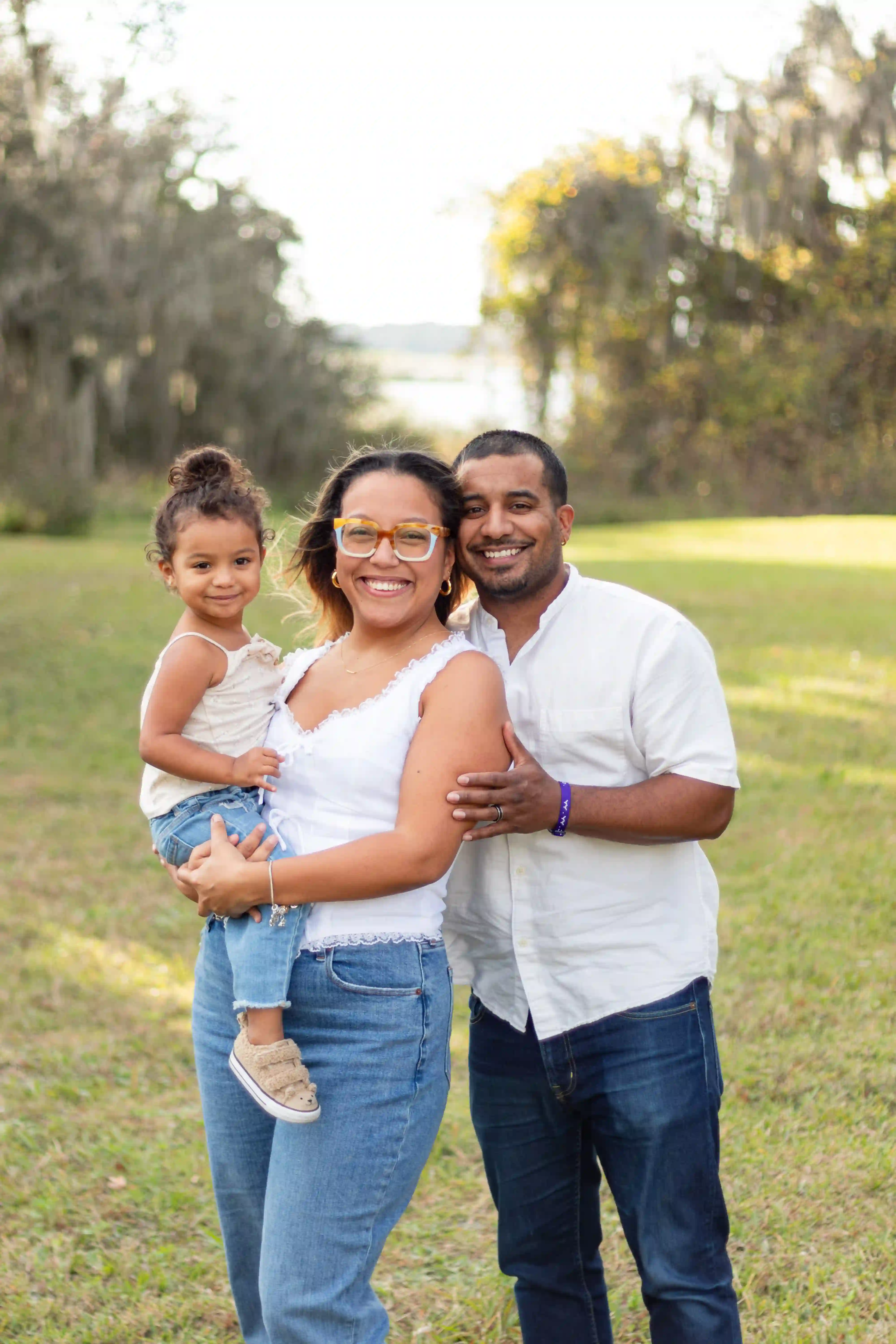 Family photo with mom and dad, mom is holding toddler daughterut